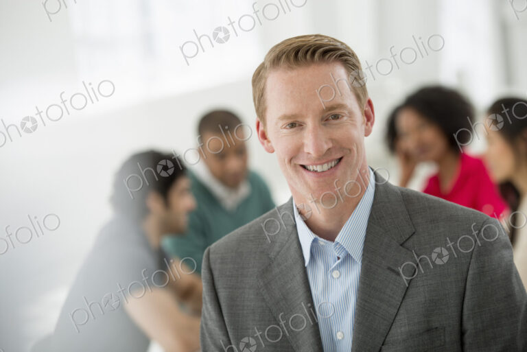 An office in the city. Business. Team meetings. A group sitting down around a table.…