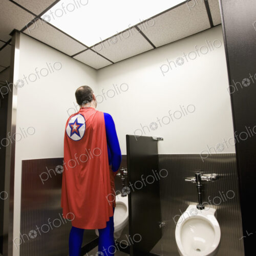 An office super hero takes a bathroom break between super hero feats. An office super hero takes a bathroom break between super hero feats.