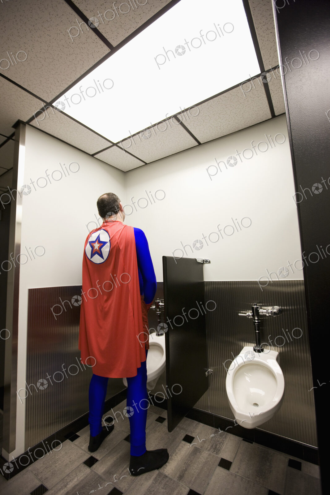 An office super hero takes a bathroom break between super hero feats.