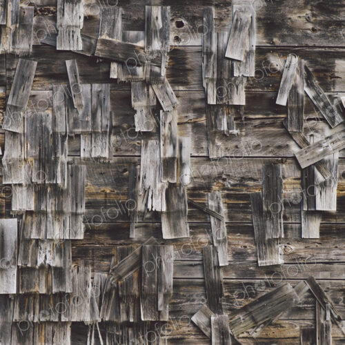 An old farmhouse with wooden shingle tiles on the walls. Silvery grey colours. An old farmhouse with wooden shingle tiles on the walls. Silvery grey colours.