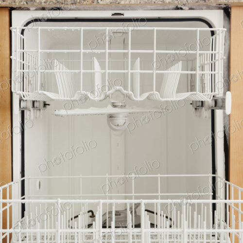An open dishwasher in a kitchen. An open dishwasher in a kitchen.
