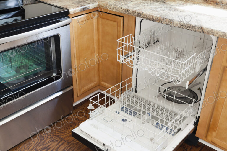 An open dishwasher in a kitchen.