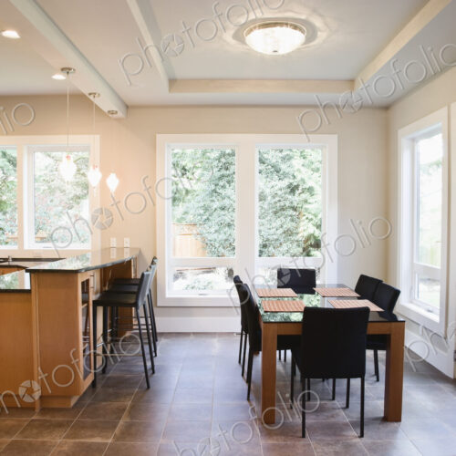 An open plan dining area and breakfast table in a new home.