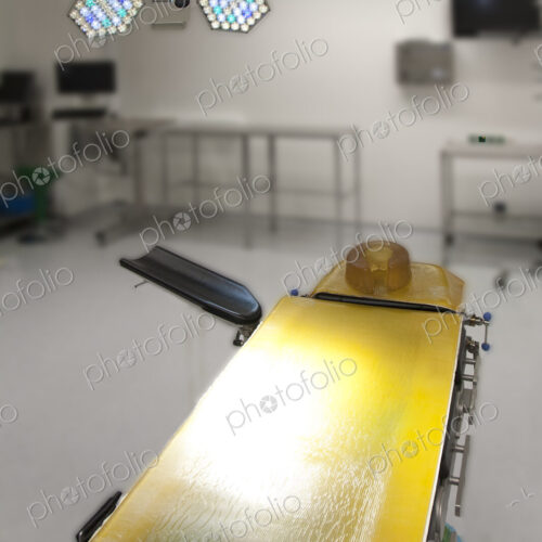 An operating table with a yellow cover in a new hospital facility