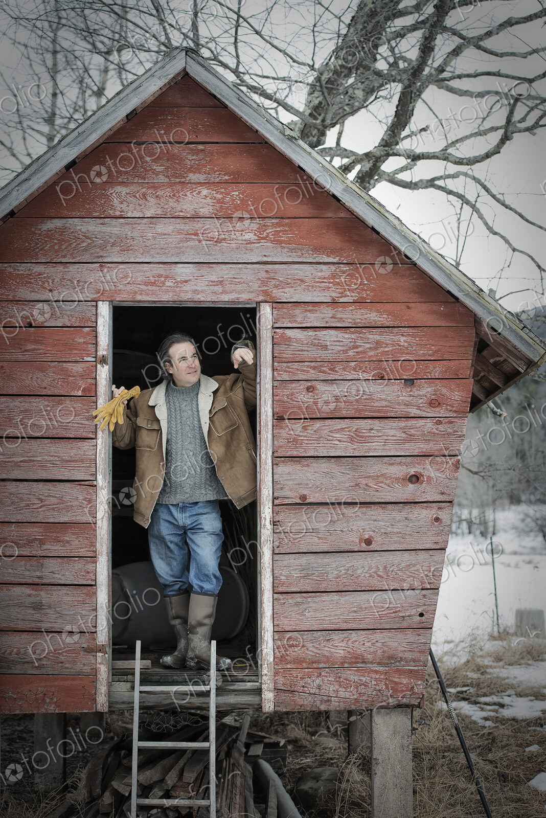 An organic farm in upstate New York, in winter. A man standing in the doorway of a…