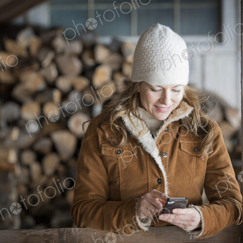 An organic farm in upstate New York, in winter. A woman in sheepskin coat and woollen… An organic farm in upstate New York, in winter. A woman in sheepskin coat and woollen…