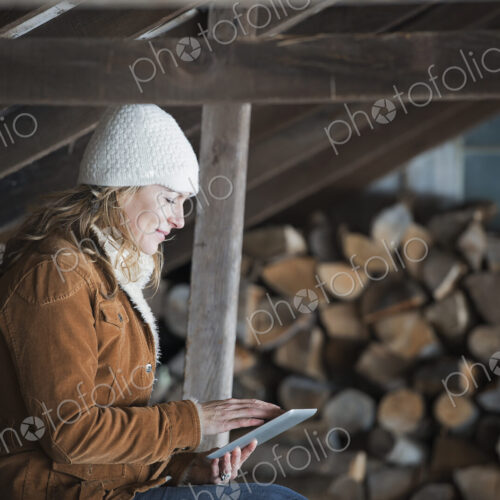 An organic farm in upstate New York, in winter. A woman sitting in an outbuilding… An organic farm in upstate New York, in winter. A woman sitting in an outbuilding…