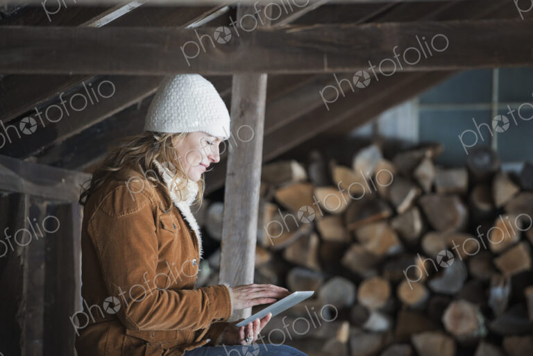 An organic farm in upstate New York, in winter. A woman sitting in an outbuilding…