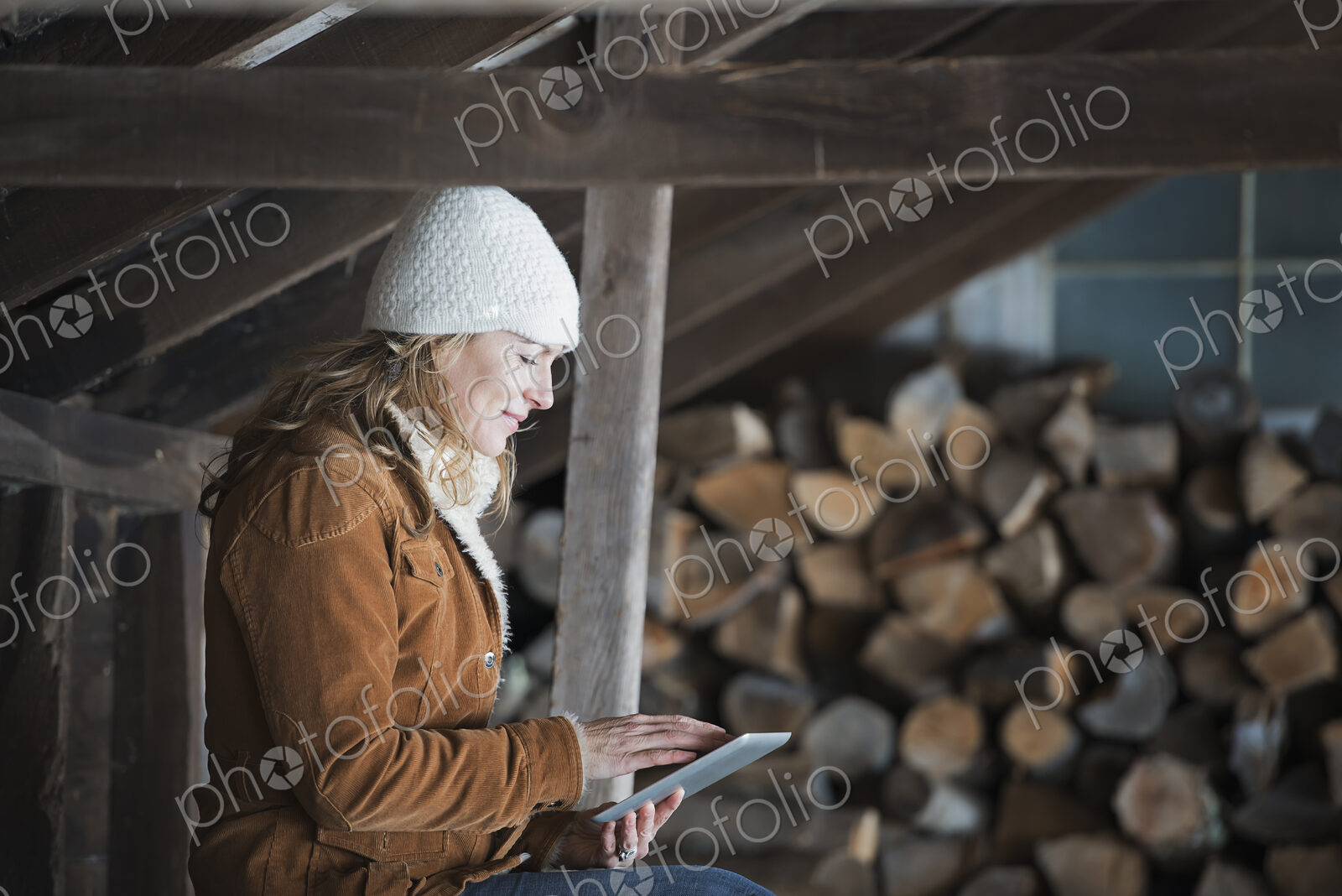 An organic farm in upstate New York, in winter. A woman sitting in an outbuilding…
