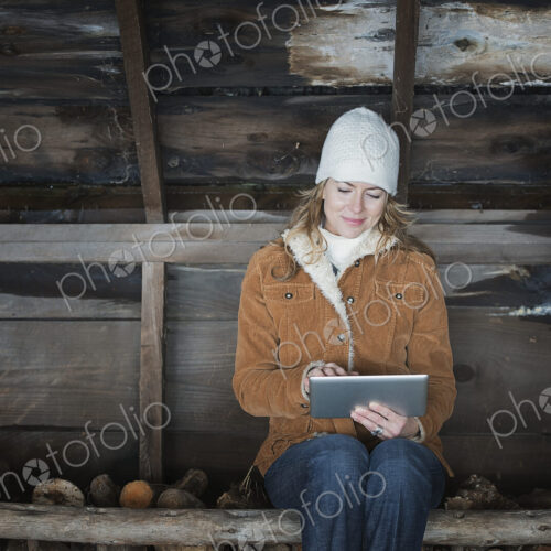 An organic farm in upstate New York, in winter. A woman sitting in an outbuilding… An organic farm in upstate New York, in winter. A woman sitting in an outbuilding…
