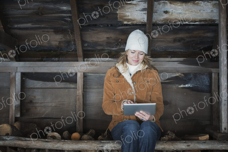 An organic farm in upstate New York, in winter. A woman sitting in an outbuilding…