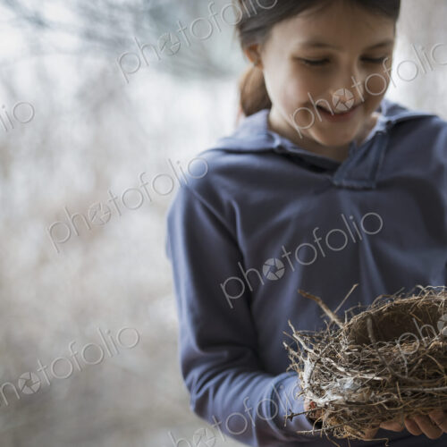 An organic farm in winter in New York State, USA. A young girl holding a bird's nest… An organic farm in winter in New York State, USA. A young girl holding a bird's nest…