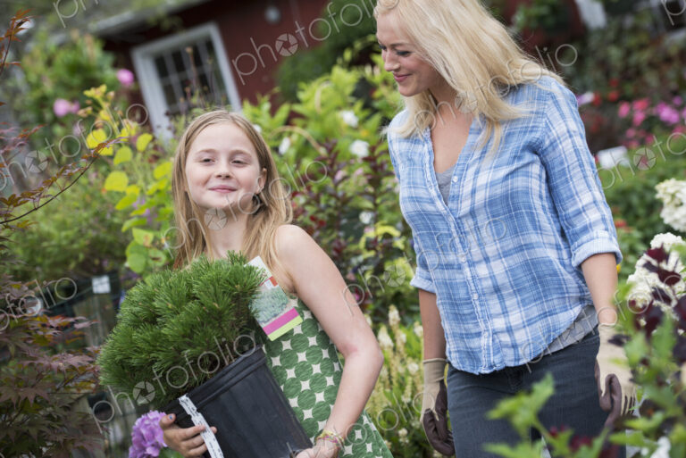 An organic flower plant nursery. A woman and a girl walking.