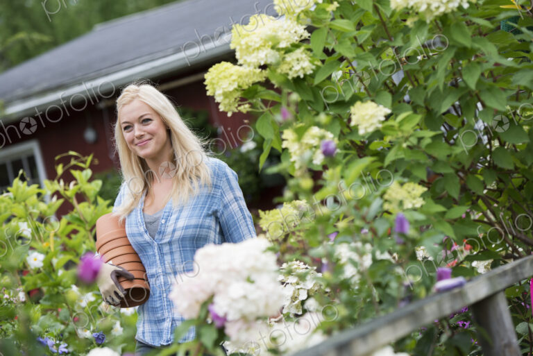 An organic flower plant nursery. A woman working.