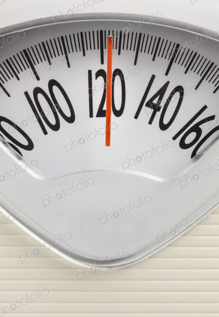 Analog bathroom scale showing 120 pounds. Health, fitness, or weight management…