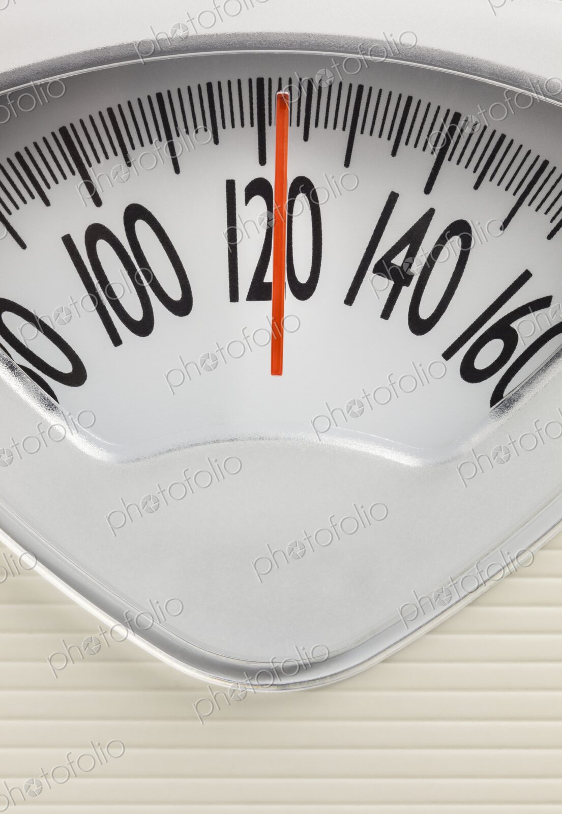 Analog bathroom scale showing 120 pounds. Health, fitness, or weight management…