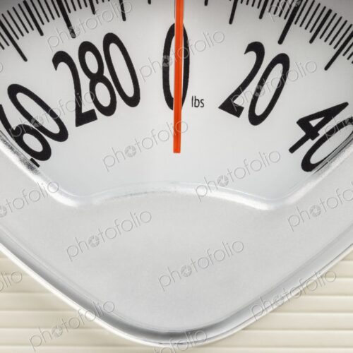 Analog bathroom scale with red needle pointing at zero. Clean, minimal concept for…