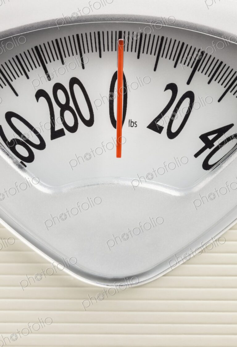 Analog bathroom scale with red needle pointing at zero. Clean, minimal concept for…