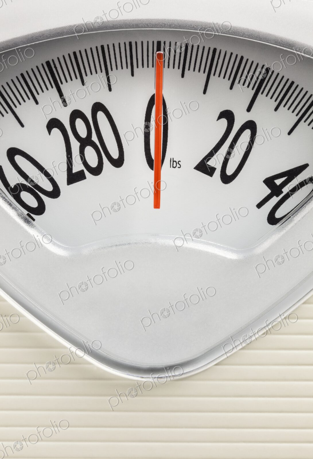 Analog bathroom scale with red needle pointing at zero. Clean, minimal concept for…