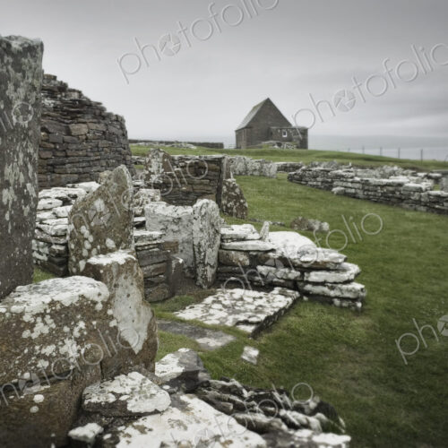 Ancient houses and stones in the Broch of Gurness, an Iron Age settlement on Orkney. Ancient houses and stones in the Broch of Gurness, an Iron Age settlement on Orkney.