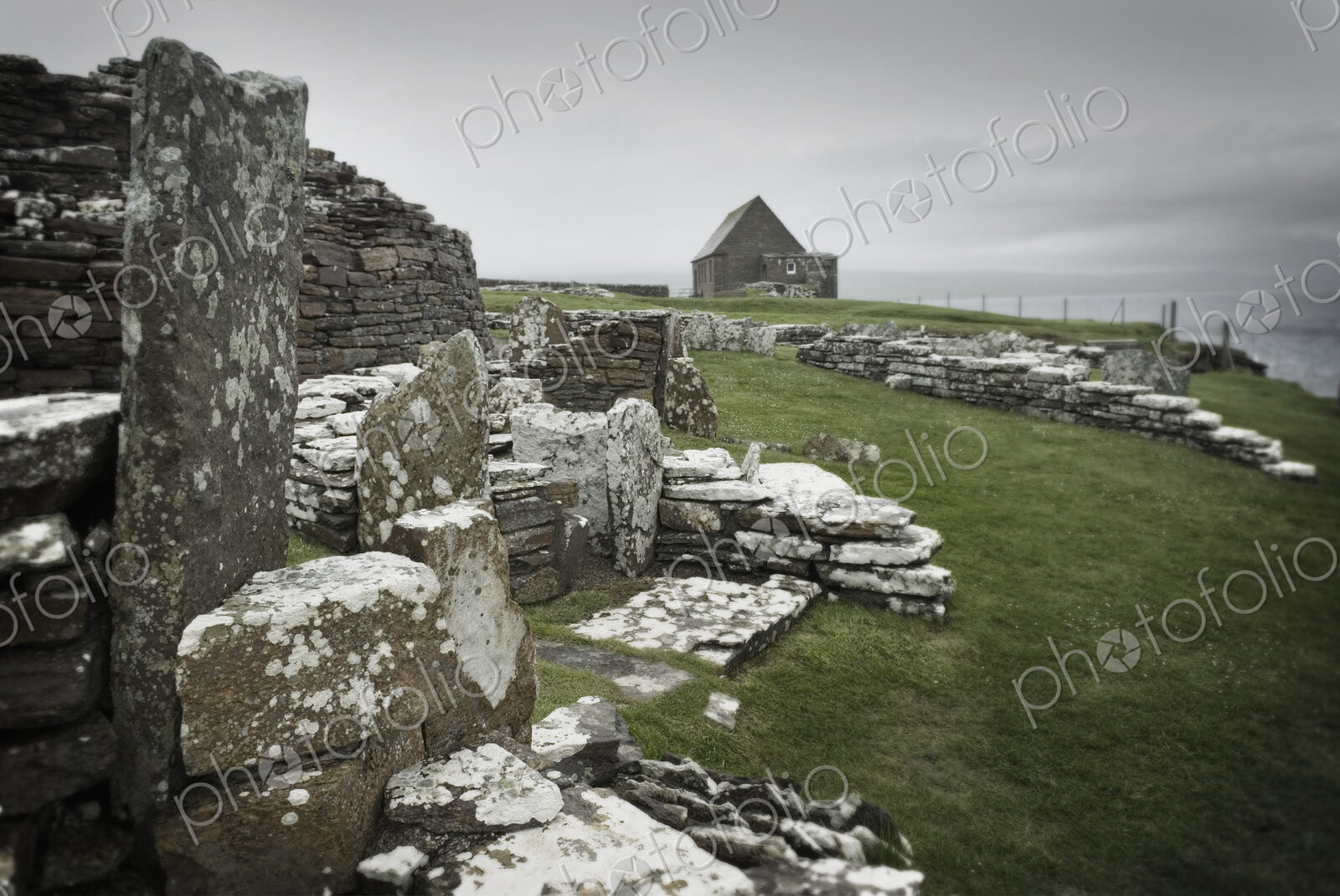 Ancient houses and stones in the Broch of Gurness, an Iron Age settlement on Orkney.