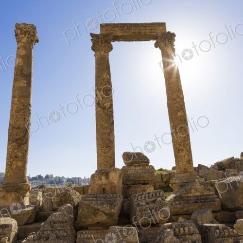 Ancient ruin of colonnade with architrave fragments and columns.