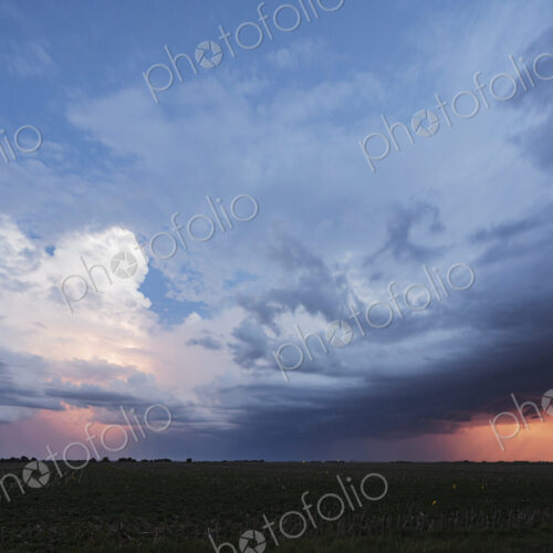 Approaching storm clouds with lightning in Nebraska, a blue sky background, glow on… Approaching storm clouds with lightning in Nebraska, a blue sky background, glow on…