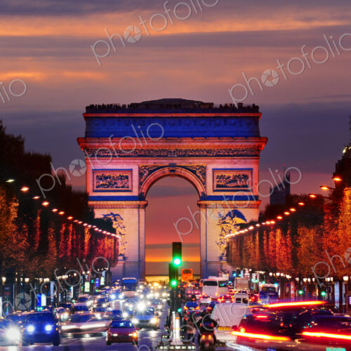 Arc de Triomphe over traffic at night, Paris, Ile-de-France, France Arc de Triomphe over traffic at night, Paris, Ile-de-France, France
