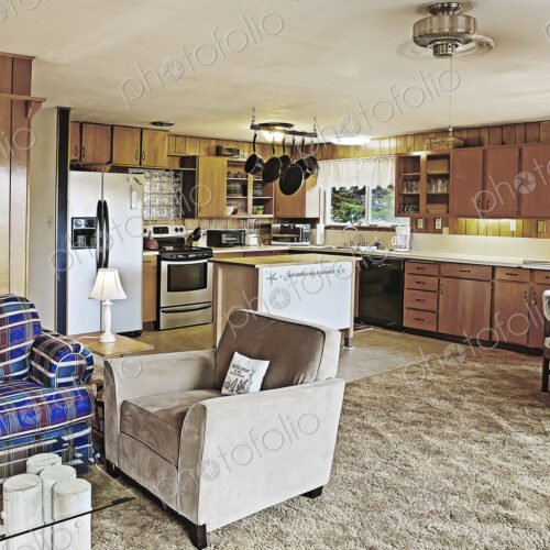 Armchair and countertops in open living room and kitchen Armchair and countertops in open living room and kitchen