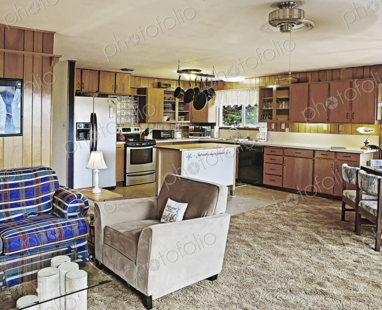 Armchair and countertops in open living room and kitchen