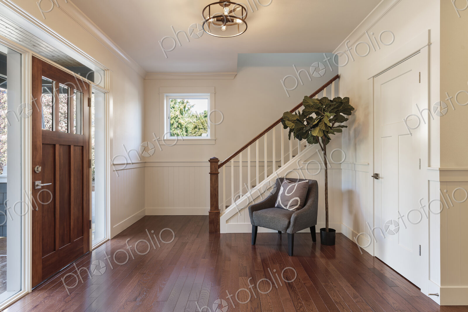 Armchair and tree in house entryway