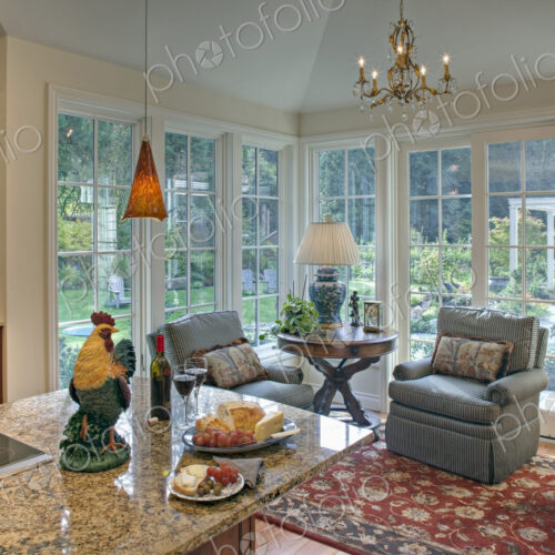 Armchairs by kitchen in luxury house