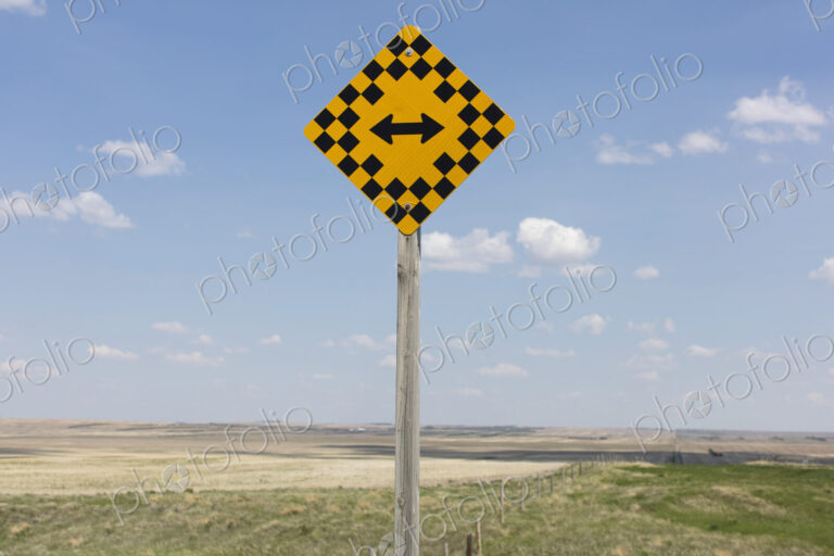Arrow intersection sign and rural farmland,