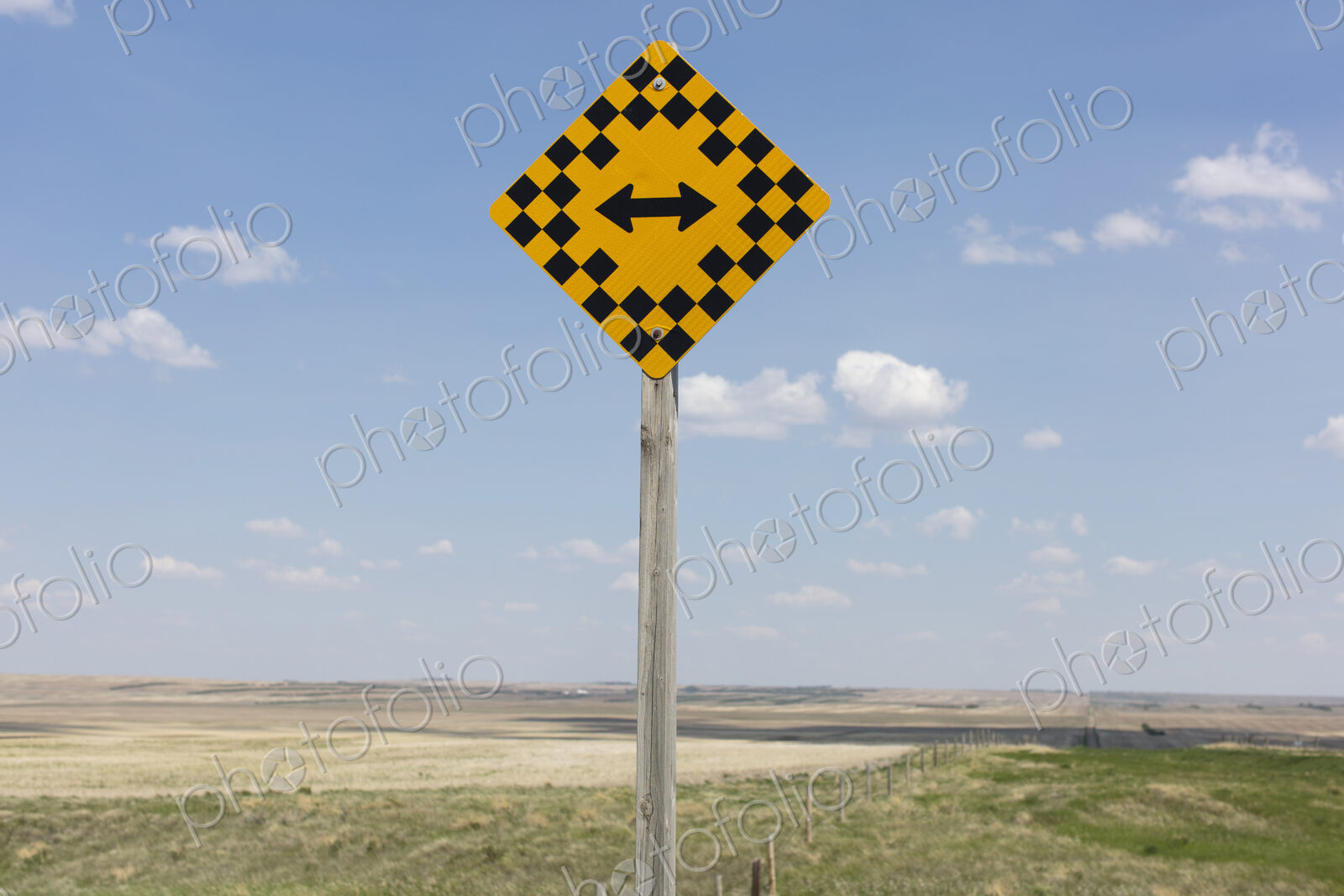 Arrow intersection sign and rural farmland,