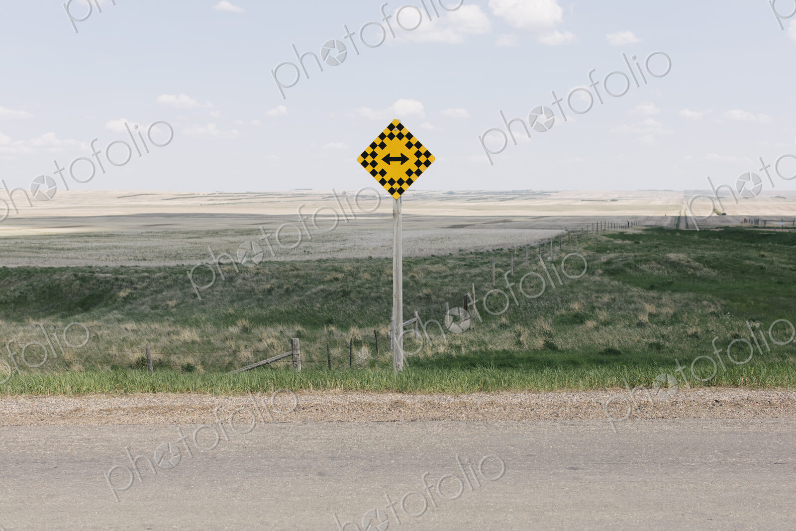 Arrow intersection sign and rural farmland,
