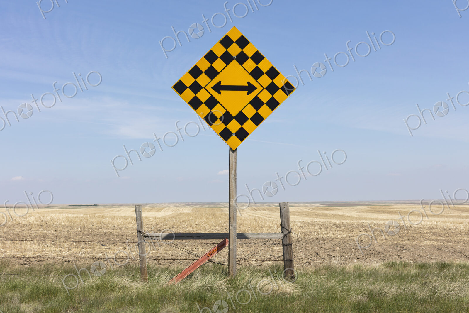 Arrow intersection sign and rural farmland