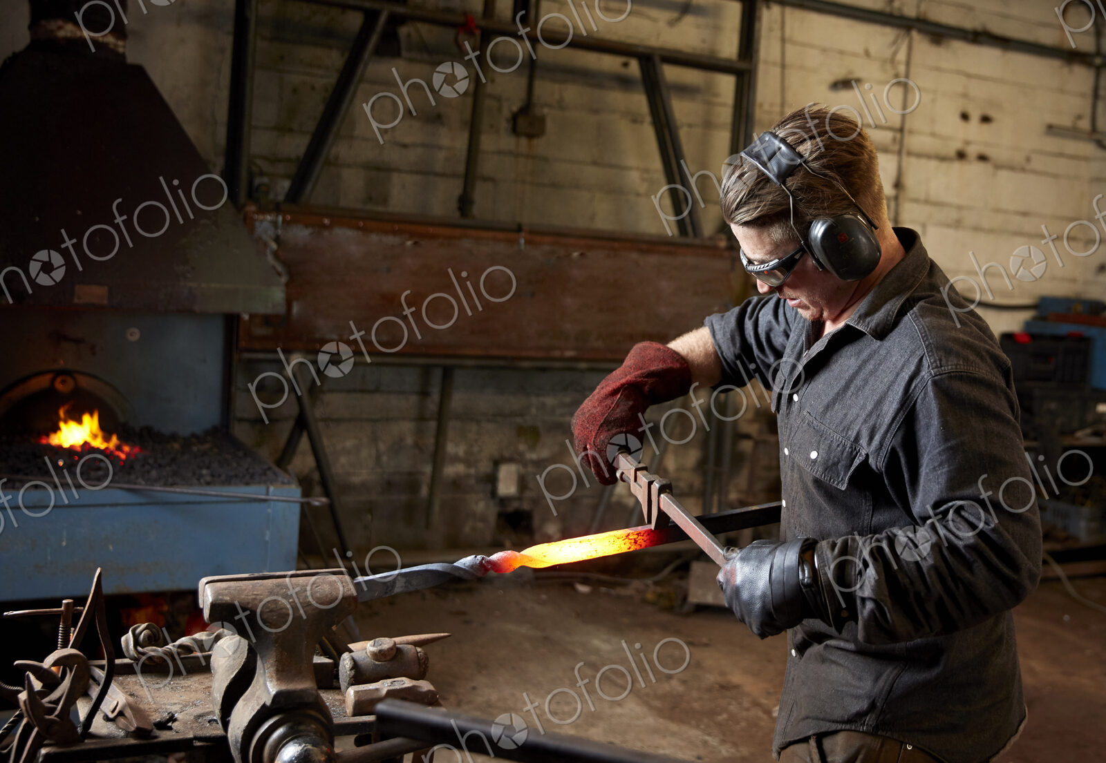 Artisan metal worker shaping a red hot piece of metal