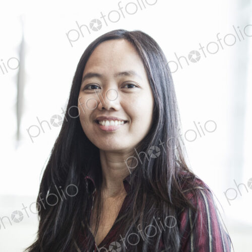 Asian business woman in a business center lobby. Asian business woman in a business center lobby.