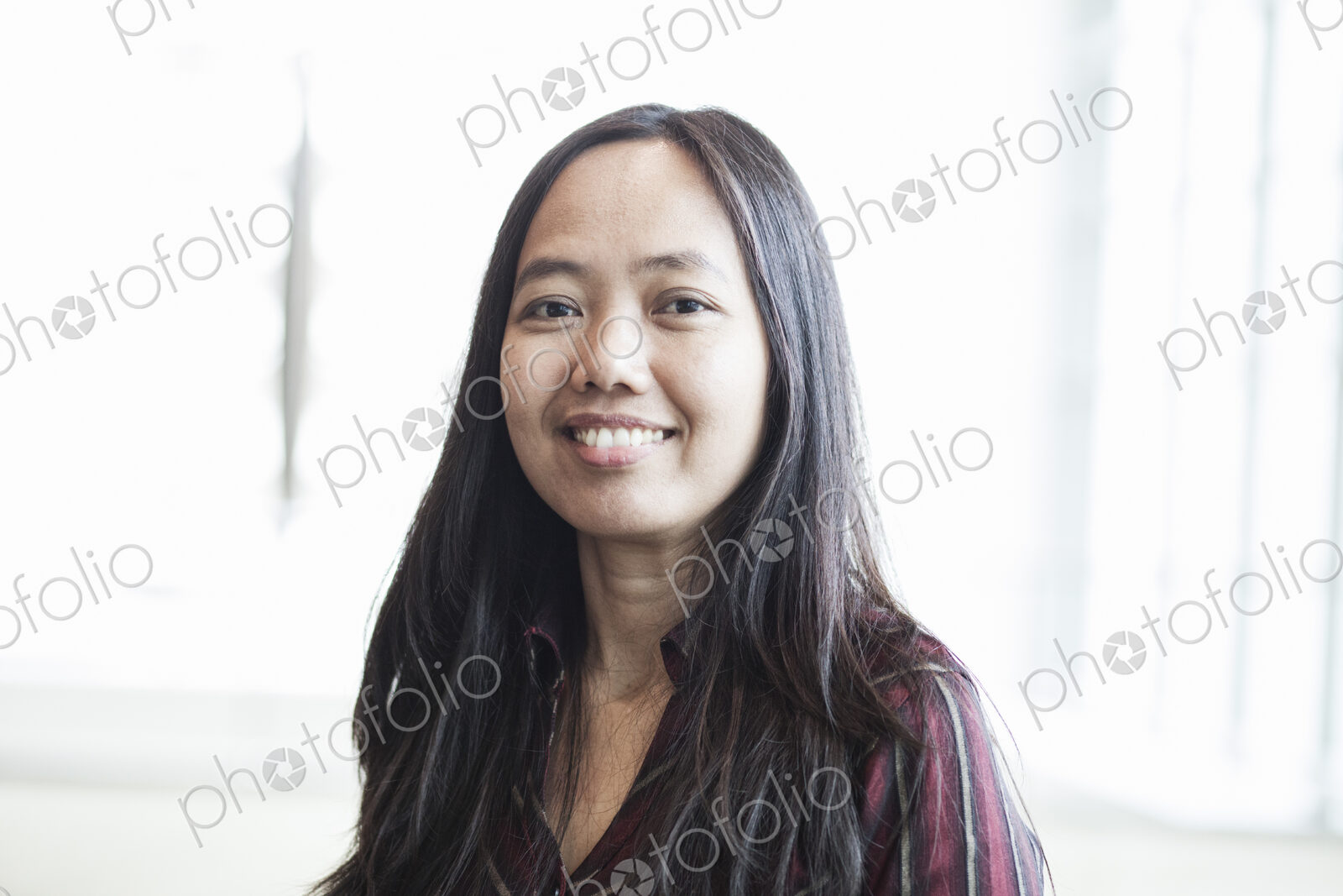 Asian business woman in a business center lobby.