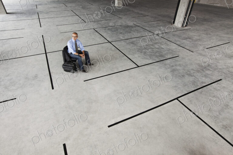 Asian businessman taking a look at a large empty raw office space.