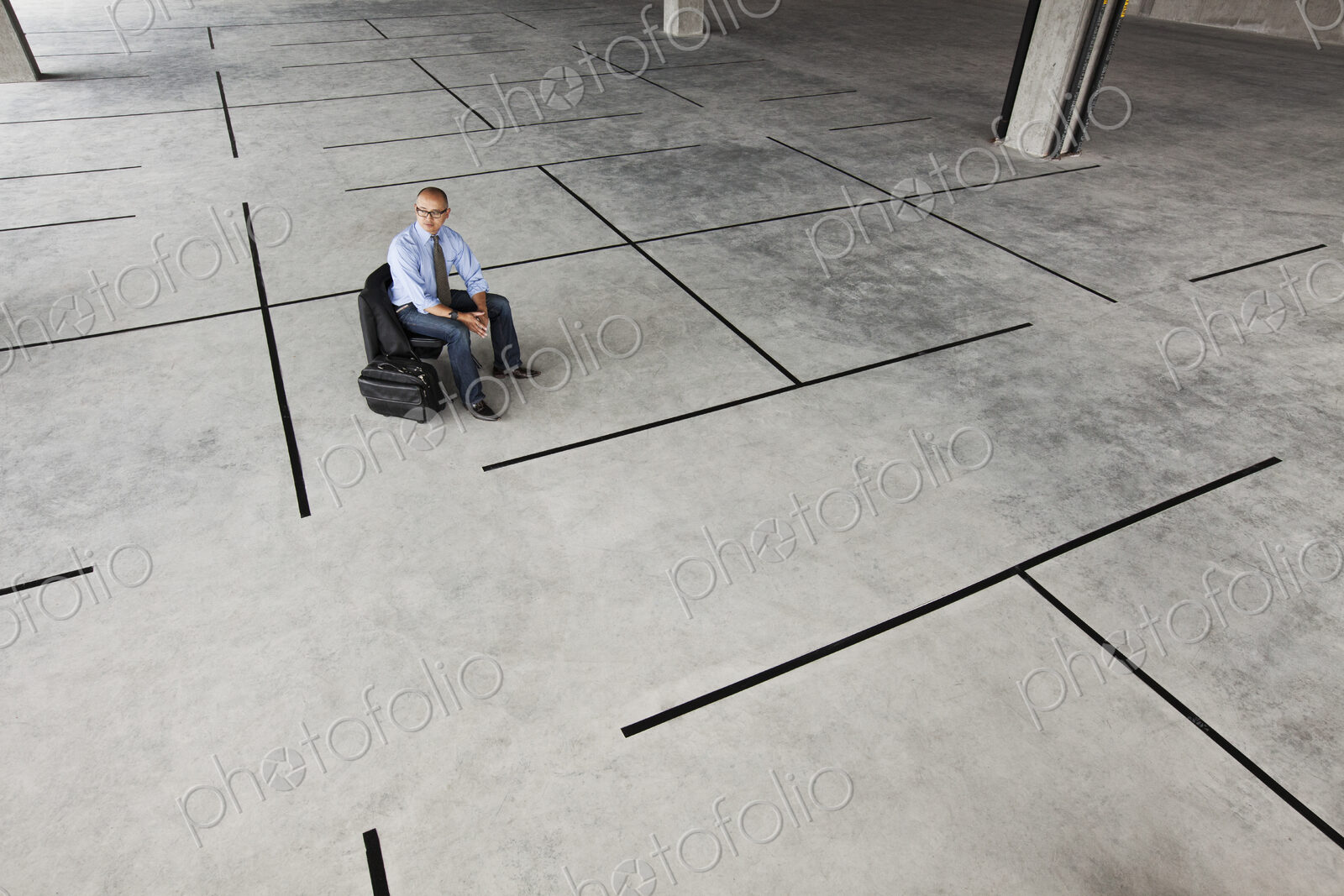 Asian businessman taking a look at a large empty raw office space.