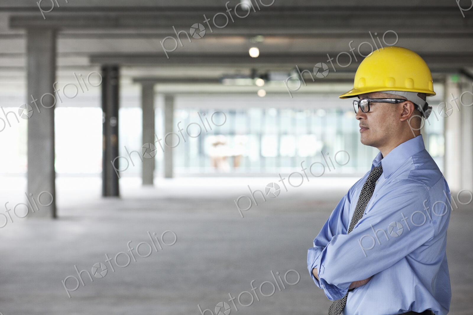 Asian businessman taking a look at a large empty raw office space.