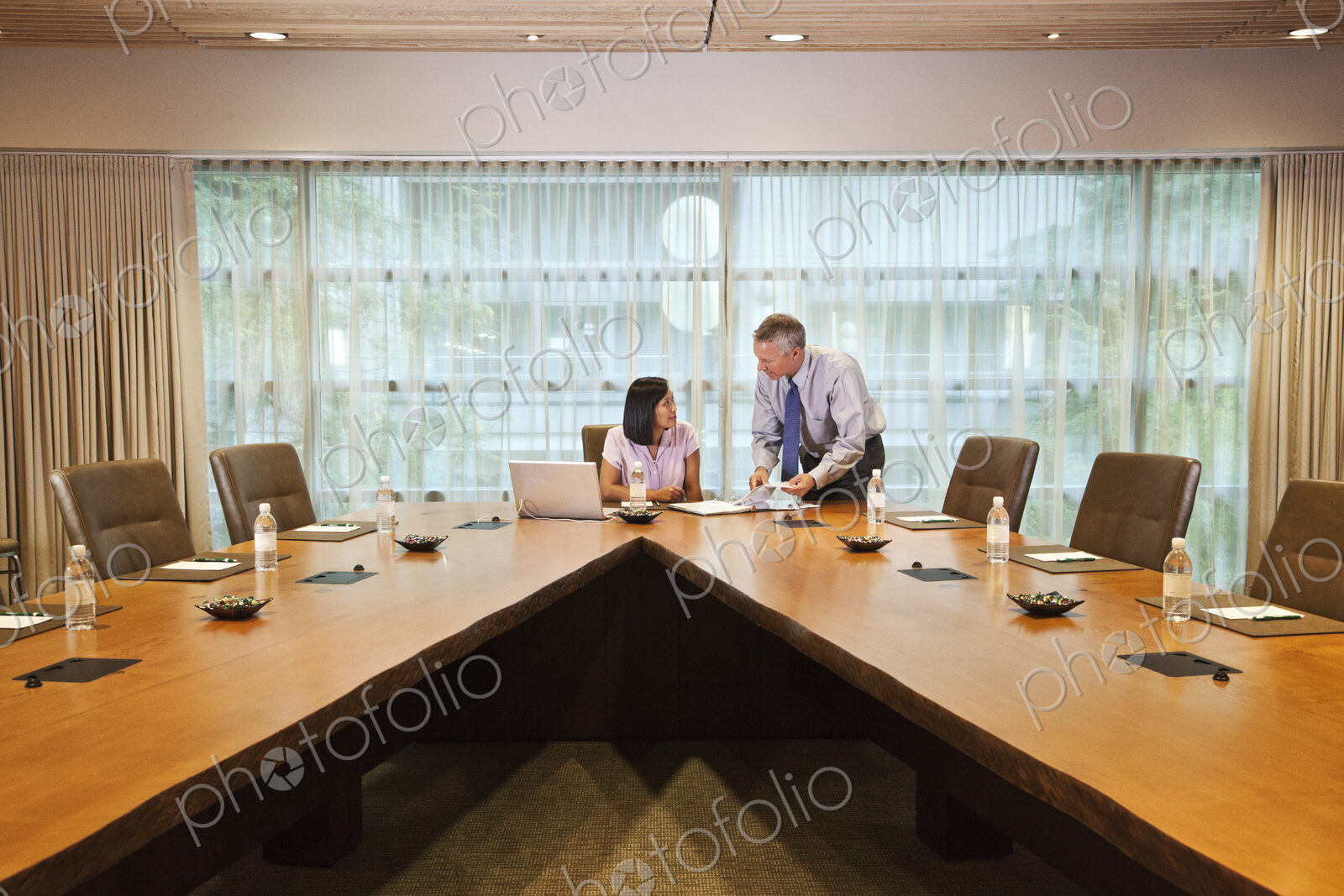 Asian businesswoman and caucasian businessman meeting in a conference room