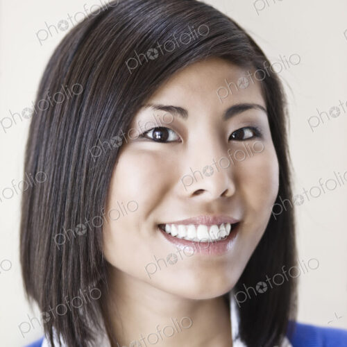 Asian businesswoman in the lobby of a large office building. Asian businesswoman in the lobby of a large office building.