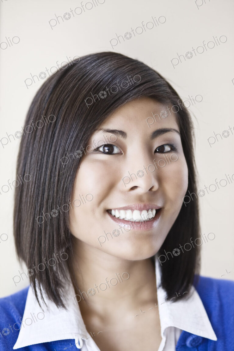 Asian businesswoman in the lobby of a large office building.