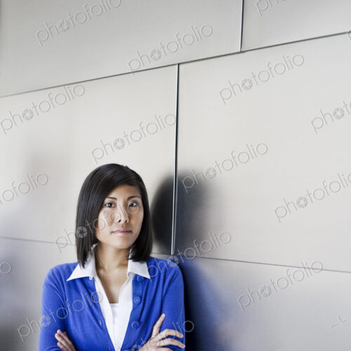Asian businesswoman in the lobby of a large office building. Asian businesswoman in the lobby of a large office building.