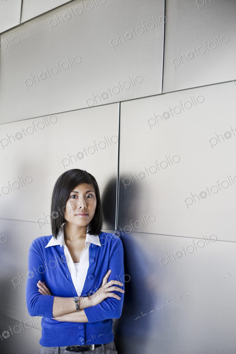 Asian businesswoman in the lobby of a large office building.