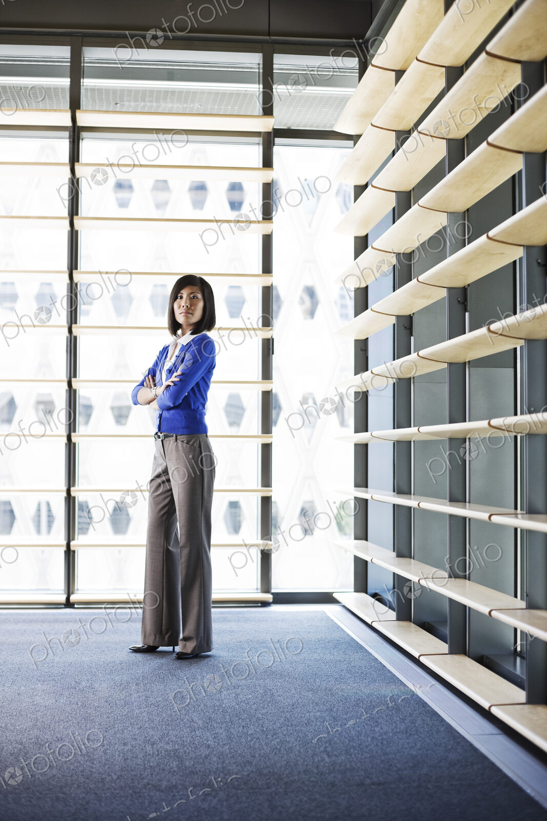 Asian businesswoman in the lobby of a large office building.