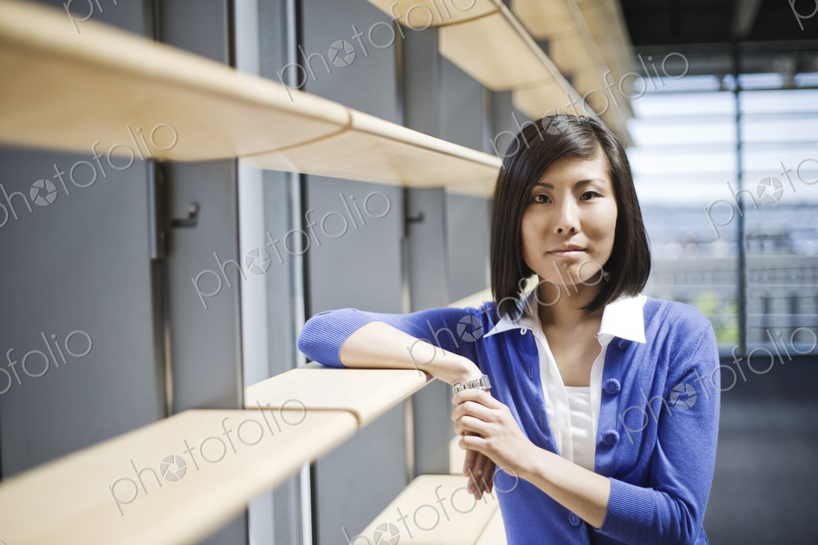 Asian businesswoman in the lobby of a large office building.