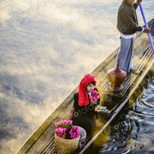Asian farmer and daughter rowing in canoe on river Asian farmer and daughter rowing in canoe on river